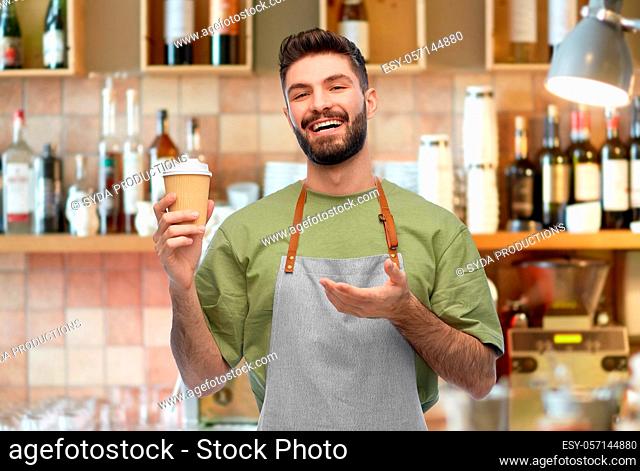 happy smiling barman in apron with takeaway coffee