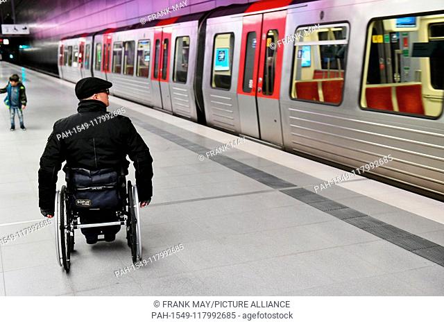 A Wheelchair user at an underground station, Germany, city of Hamburg, 05. March 2019. Photo: Frank May (model released) | usage worldwide