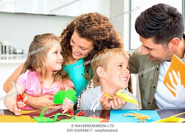 Smiling young family doing arts and crafts at the table