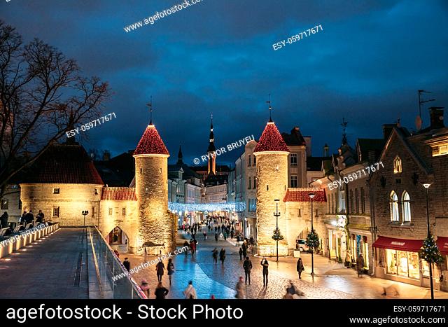Tallinn, Estonia. People Walking Near Famous Landmark Viru Gate In Street Lighting At Evening Or Night Illumination. Christmas, Xmas