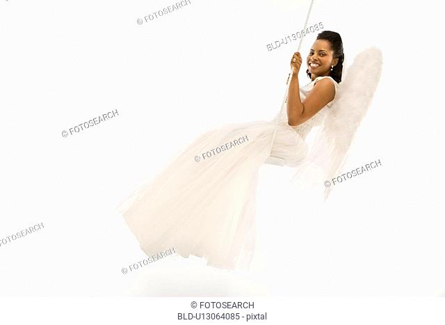 Angelic Mid-adult African-American bride swinging