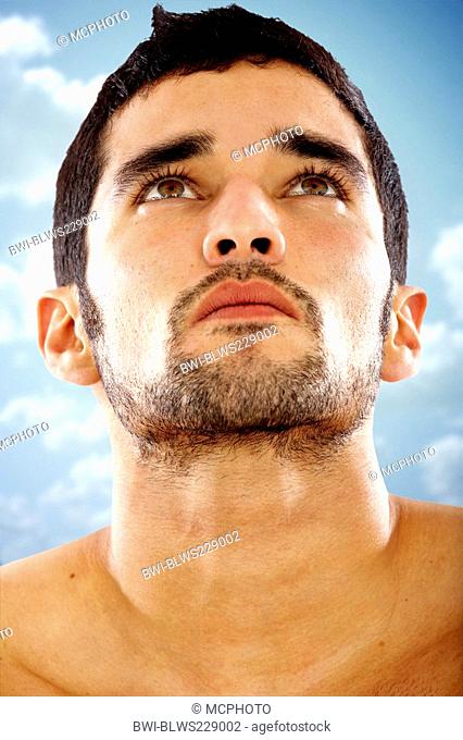 fashion male portrait looking away deep in thought outdoors