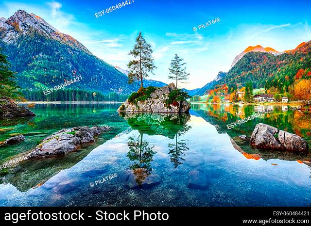 Fantastic autumn sunrise of Hintersee lake. Beautiful scene of trees on a rock island. Location: resort Ramsau, National park Berchtesgadener Land