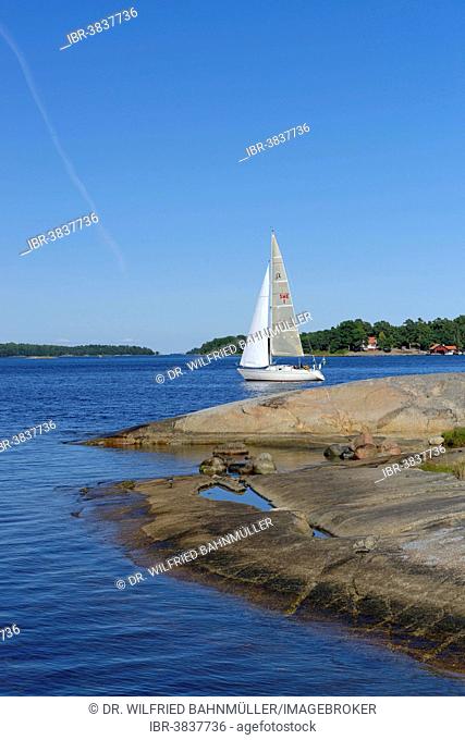 Sailboat and typical round polished rocks, roches moutonnées, on Finnhamn Island in the Stockholm Middle Archipelago, Stockholm, Sweden