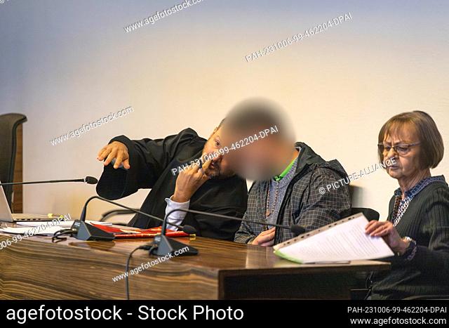 06 October 2023, Baden-Württemberg, Freiburg: The defense attorney (l) speaks with the defendant (M); an interpreter sits on the right