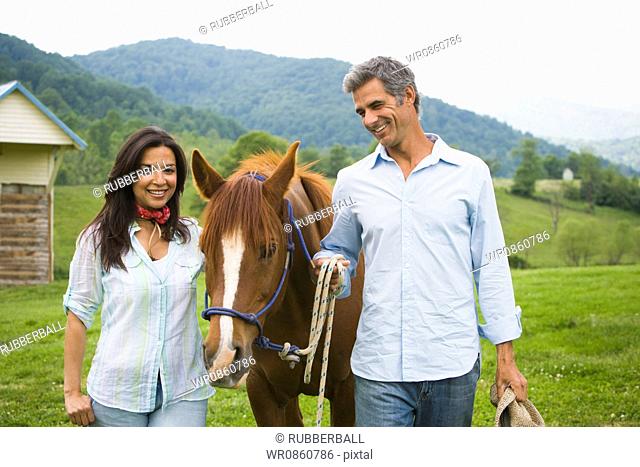 man and a woman with a horse