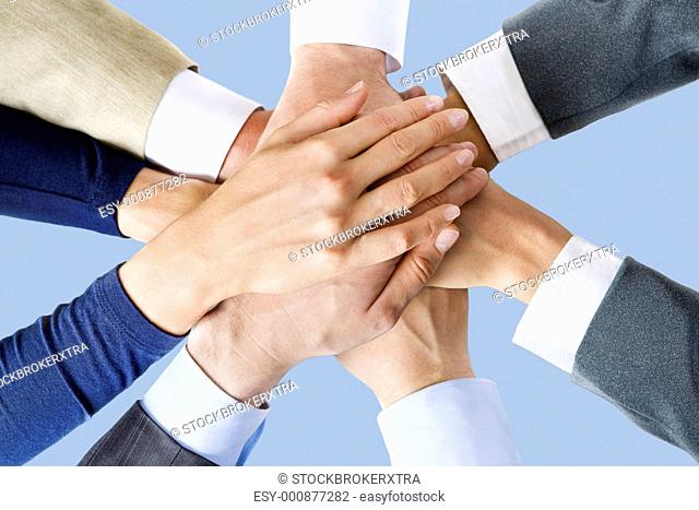 Photo of business peoples hands on top of each other