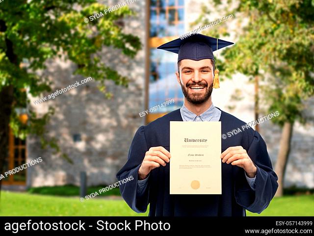male graduate student in mortar board with diploma