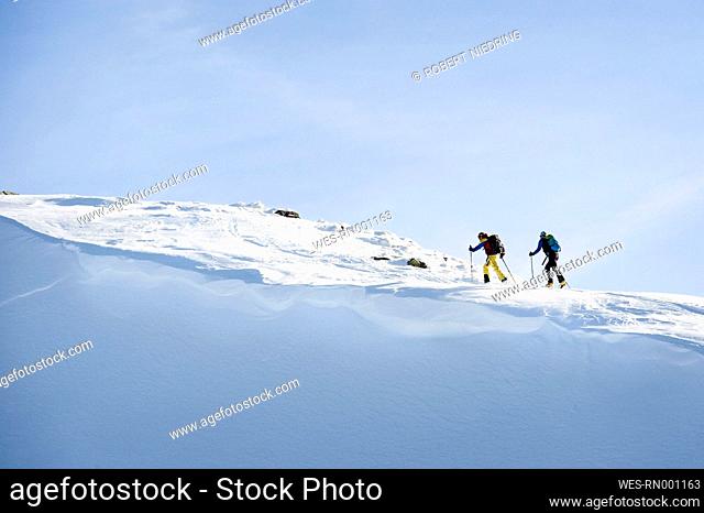 Austria, Men skiing on mountain at Alpbachtal