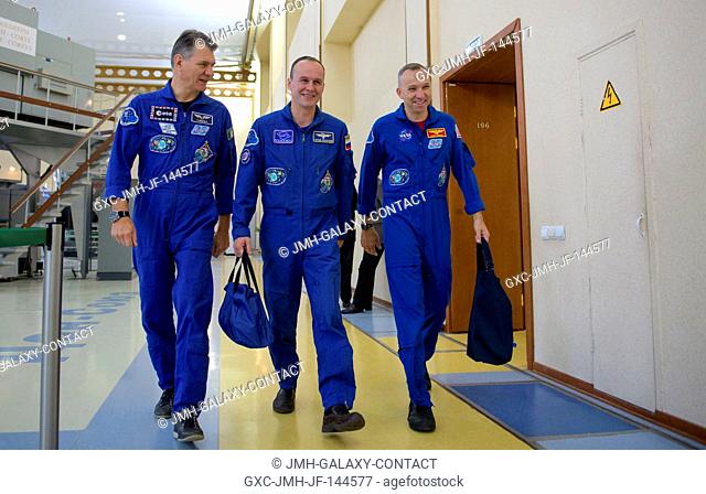 Expedition 52 flight engineers Paolo Nespoli of ESA, left, Sergey Ryazanskiy of Roscosmos, and Randy Bresnik of NASA prepare to don their Russian Sokol suits...