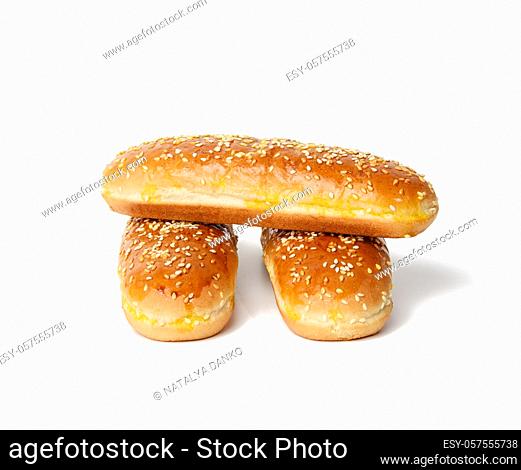 baked oval hot dog bun, baked goods sprinkled with sesame seeds and isolated on white background, stack