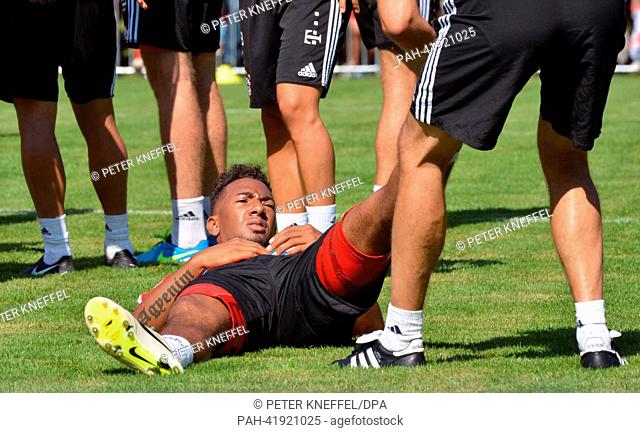 FC Bayern Munich's Jerome Boateng receives a massage during a practice session of his team on a pitch of a sponsor in Munich, Germany, 21 August 2013