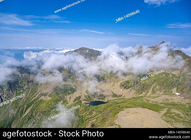 terenten, bolzano province, south tyrol, italy. deep view of the tiefratsenhütte and the tiefrastensee, in the back left the eidechspitze
