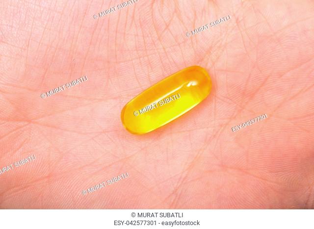 Omega 3 capsules in woman hands