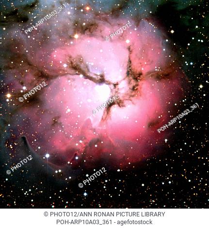 Spitzer Space Telescope composite visible-light and infrared views of the glowing Trifid Nebula, a giant star-forming cloud of gas and dust located in the...