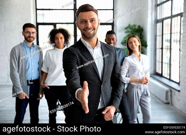 Head shot portrait confident smiling businessman offering hand for handshake, looking at camera, friendly hr manager team leader welcoming new worker