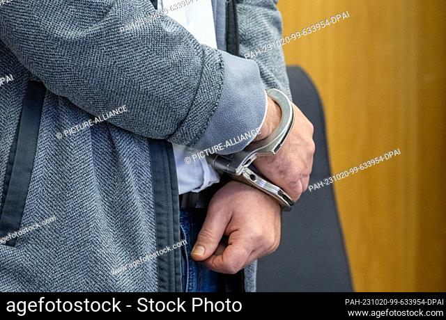 20 October 2023, Baden-Württemberg, Ulm: A man stands in the district court with his hands tied. The defendant allegedly tried to set fire to the apartment of...