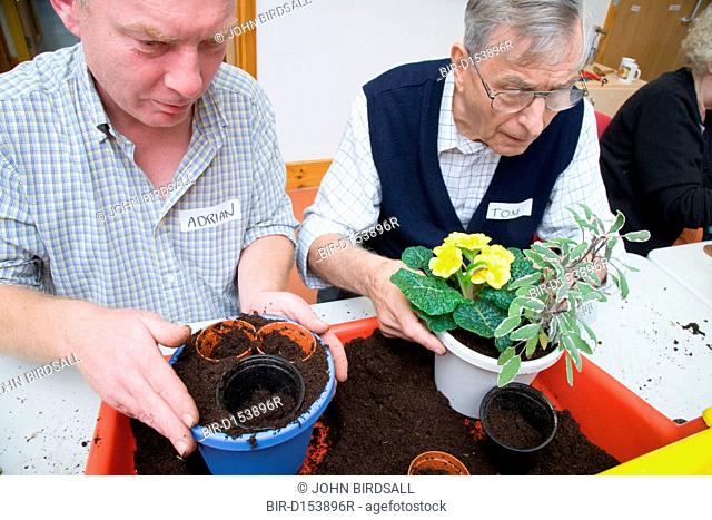 Men taking part in a Thrive gardening workshop for visually impaired people visiting the NRSB, The use of yellow and red boxes help visually impaired people...