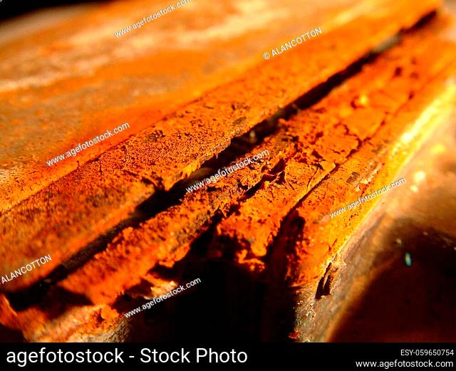 A few metal plates with heavy red rust showing