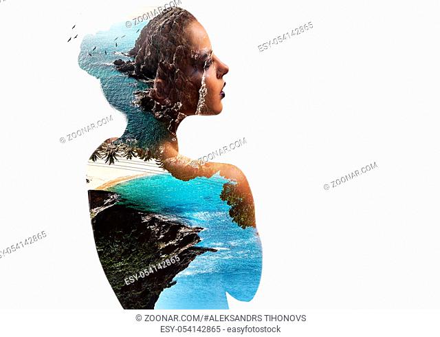 Silhouette of a woman combined with a rocky coast and sea. Double exposure