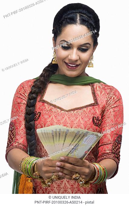Woman holding Indian paper currency