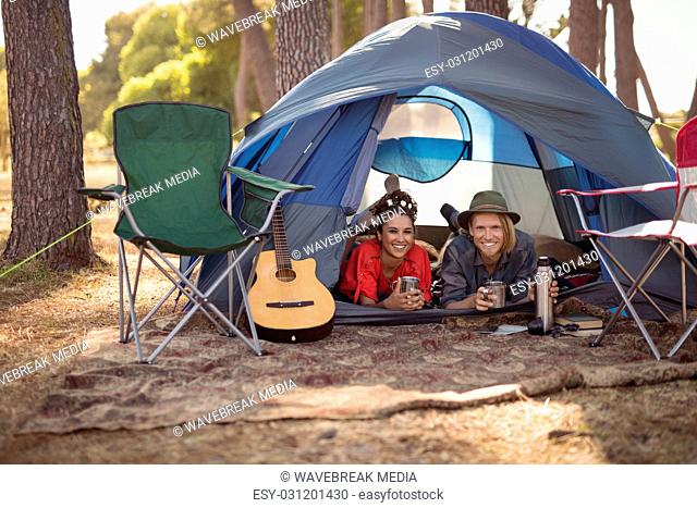 Portrait of couple relaxing in tent
