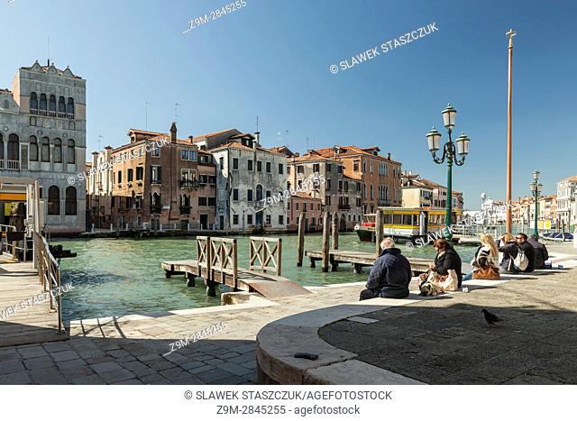 People waiting for vaporetto in the sestiere of Cannareggio, Venice, Italy