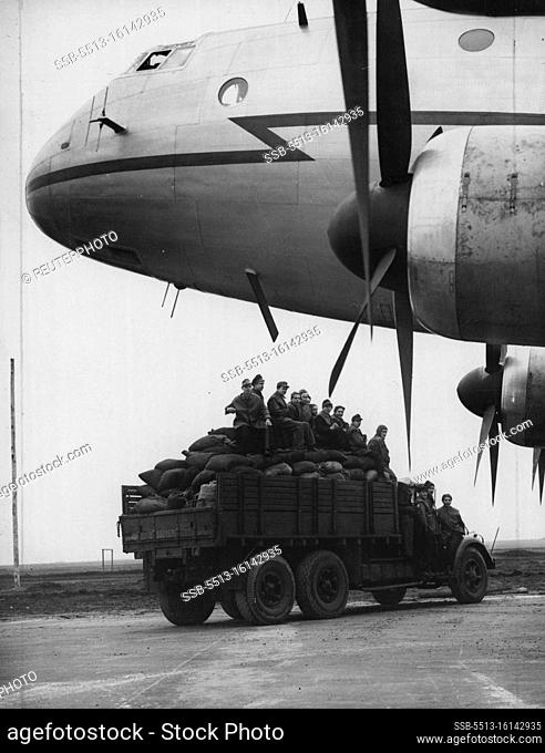 Fuel For Berlin By The Airlift Coalmen -- A lorry loaded with sacks of coal passes under the nose of the ""aerial coalman"", a giant Ha stings aircraft