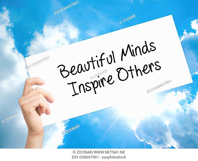 Beautiful Minds Inspire Others Sign on white paper. Man Hand Holding Paper with text. Isolated on sky background