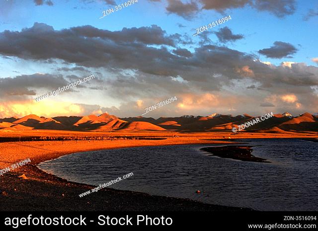 Landscape of mountains and lakes in Tibet at sunset