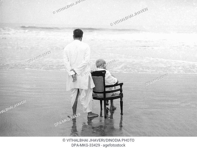 Mahatma Gandhi with his son Devdas at Juhu Beach, Mumbai, Maharashtra, India, May 1944 - MODEL RELEASE NOT AVAILABLE