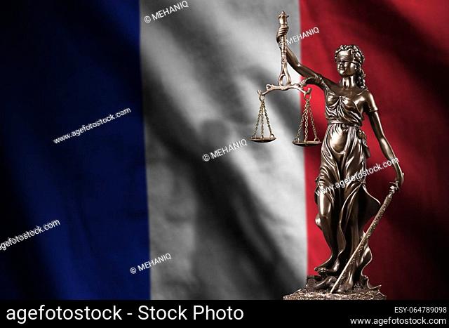 France flag with statue of lady justice and judicial scales in dark room. Concept of judgement and punishment, background for jury topics