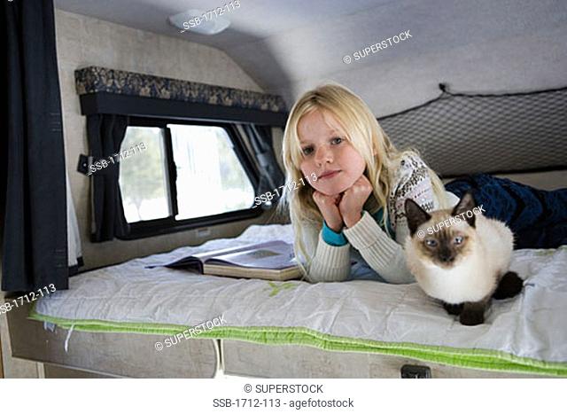 Girl lying on a bed in a recreational vehicle