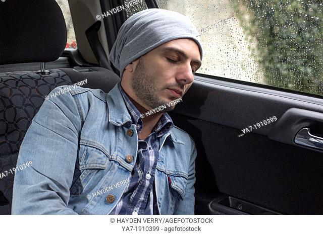 Young Man Sleeping in Car