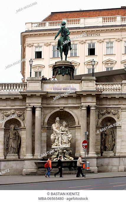 Tourists standing under the equestrian statue of Albrecht in front of the art museum Albertina in Vienna