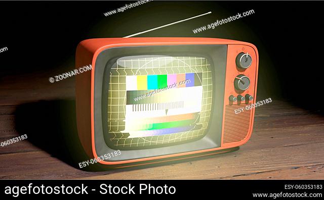 A old red etro TV with test image in the darkness on wooden underground