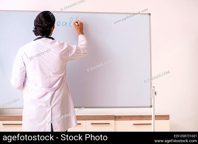 Young doctor in front of whiteboard