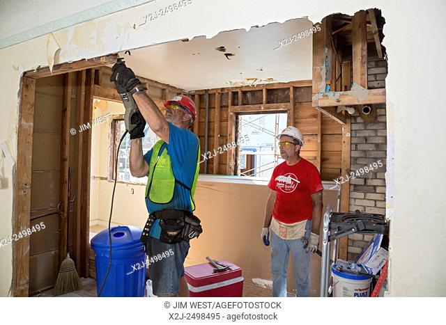 Detroit, Michigan - Volunteers help to rehabilitate a house as part of Habitat for Humanity's week-long campaign to build or rehab 12 houses in Detroit's...