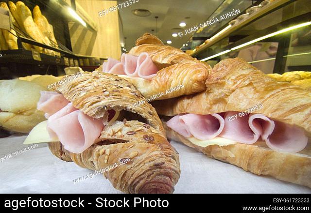 Ham and cheese croissants. Bakery background at bottom