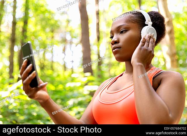 african american woman with headphones and phone