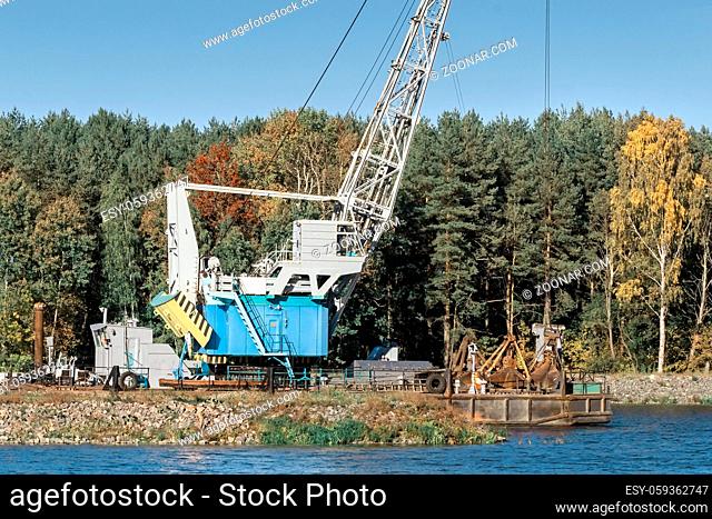 Environmental protection. On the river Bank mechanism for cleaning the river bottom and deepening the river for navigation