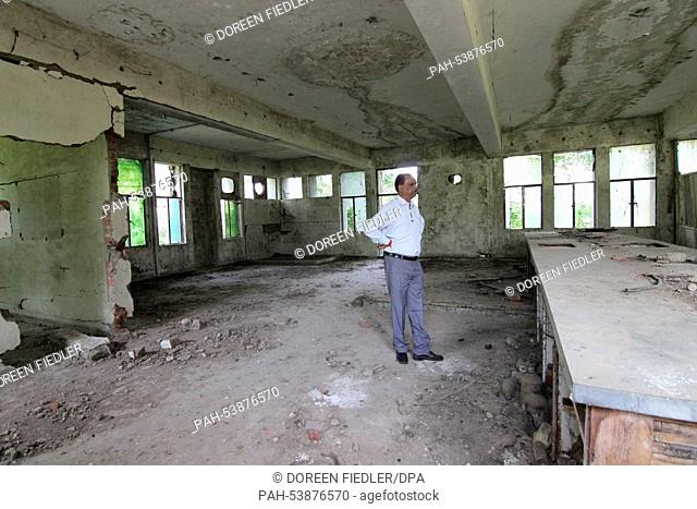 T. R. Chouhan stands in an old factory buildings of the Union Carbide Factory, where once he worked as plant director in Bhopal, India, 28 October 2014