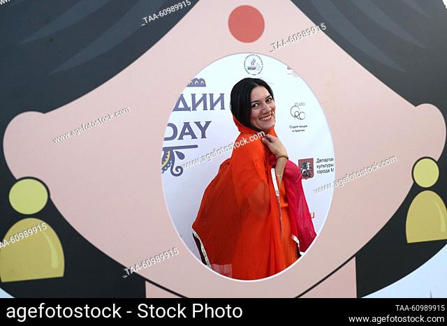 RUSSIA, MOSCOW - AUGUST 10, 2023: A woman in a shawl is seen through an opening in a cutout on the opening day of the 8th India Day festival in Ostrov Mechty...