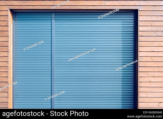 modern wooden siding with gray aluminum shutters