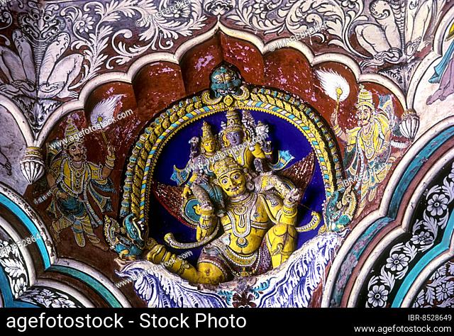 Vishnu with his consort seated on garuda 18th century stucco works and wonderful fresco painted pillars of Maratha Darbar hall inside Thanjavur palace complex
