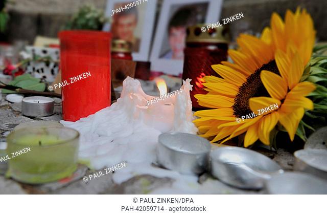Flowers, candles and cards sit on the ground in front of the Rheingau school in Berlin, Germany, 27 August 2013. According to the Foreign Office