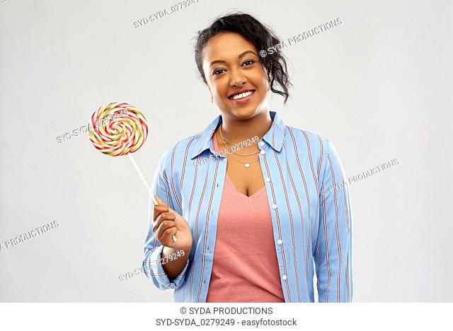happy african american woman with big lollipop