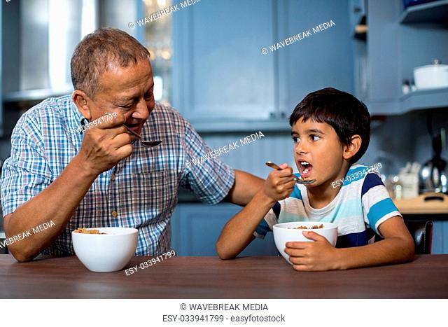 Grandfather and grandson having breakfast