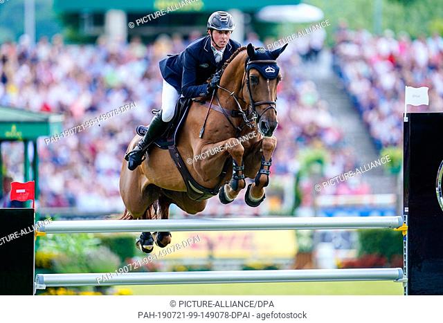 21 July 2019, North Rhine-Westphalia, Aachen: Equestrian sports, CHIO, jumping: Show jumper Ben Maher from Great Britain on his horse Explosion jumps over an...
