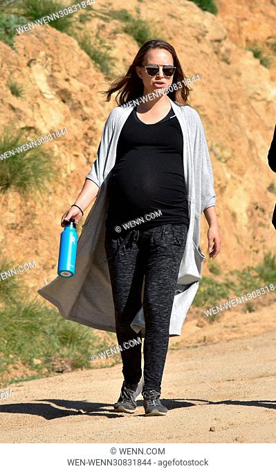 A heavily pregnant Natalie Portman goes for a walk in joggers, a loose cardigan, and a tight cami that hugs her big belly Featuring: Natalie Portman Where: Los...